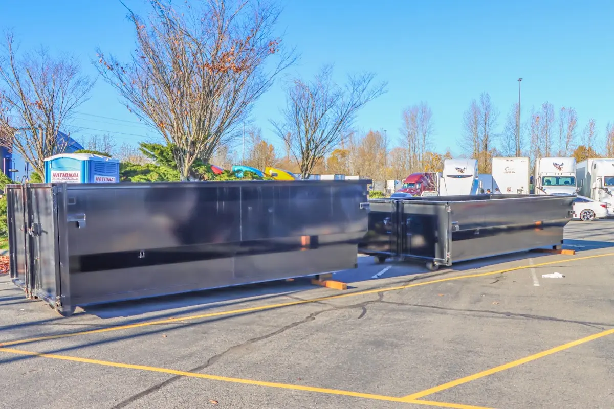 Professional dumpster rental service with roll-off container on residential driveway in West Palm Beach